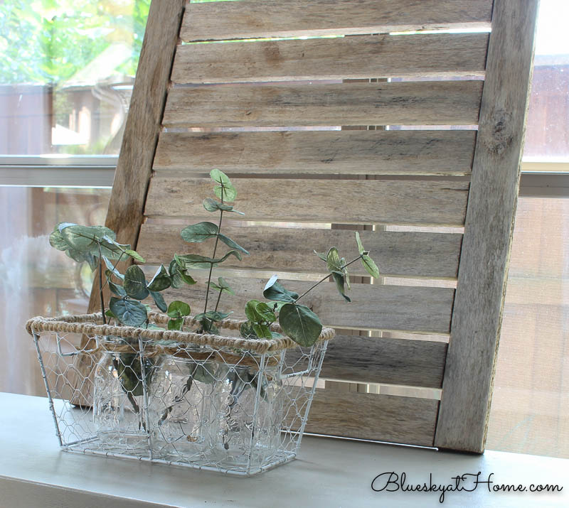 wire basket display and weathered shutter