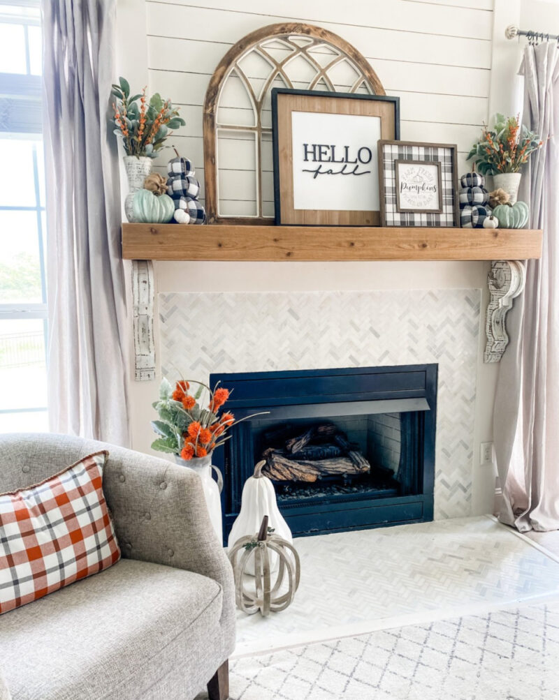 fall mantel with pictures and signs