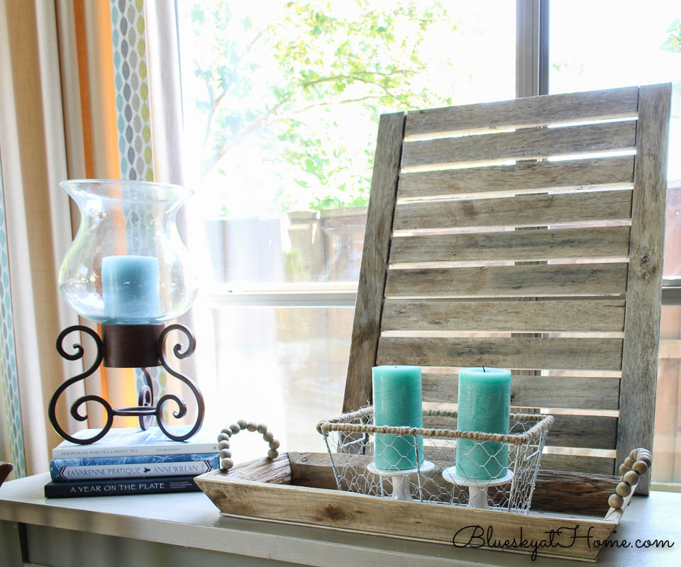 teal candles in wire basket