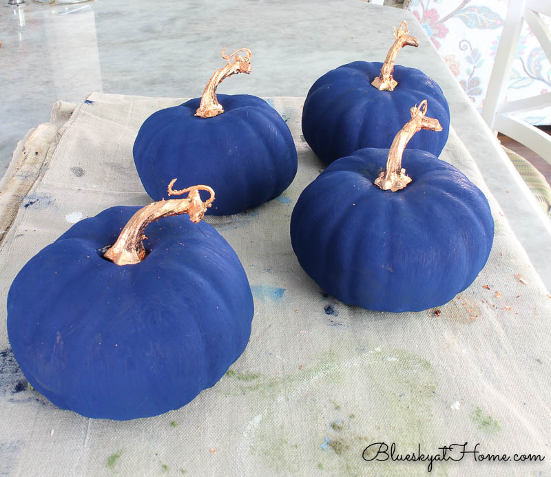 blue painted pumpkins with copper stems