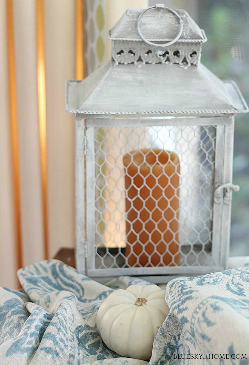 orange candle in wire lantern