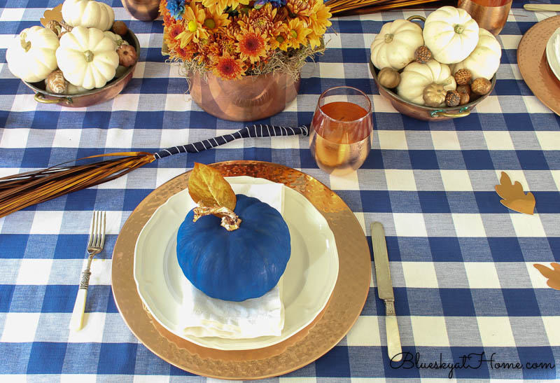 blue pumpkin on white plate and charger