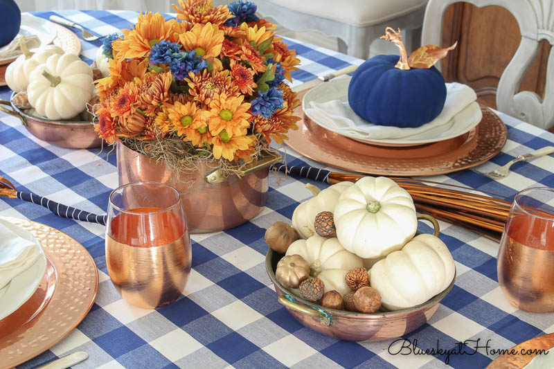 white pumpkins in copper dish with copper glass