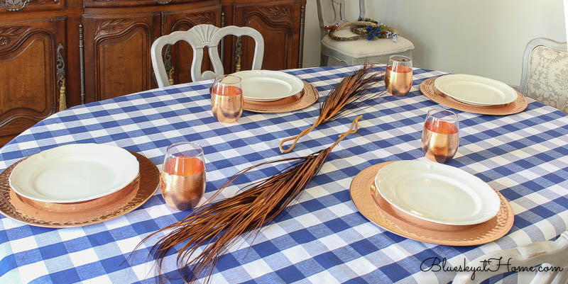 blue and white checked tablecloth with copper accents
