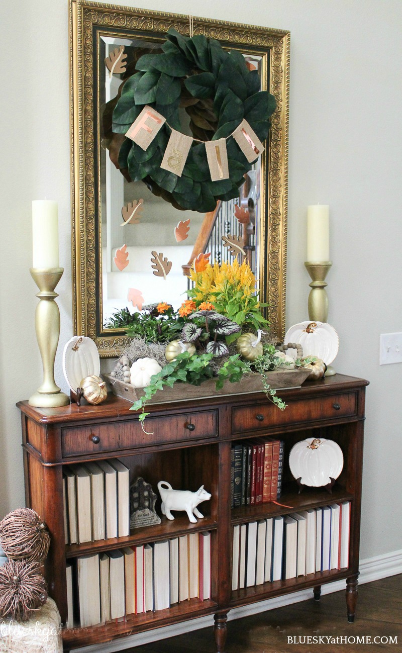 entry console decorated with vintage fall decor