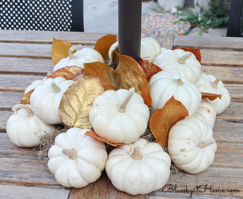 fall patio tablescape white pumpkins with gold leaves