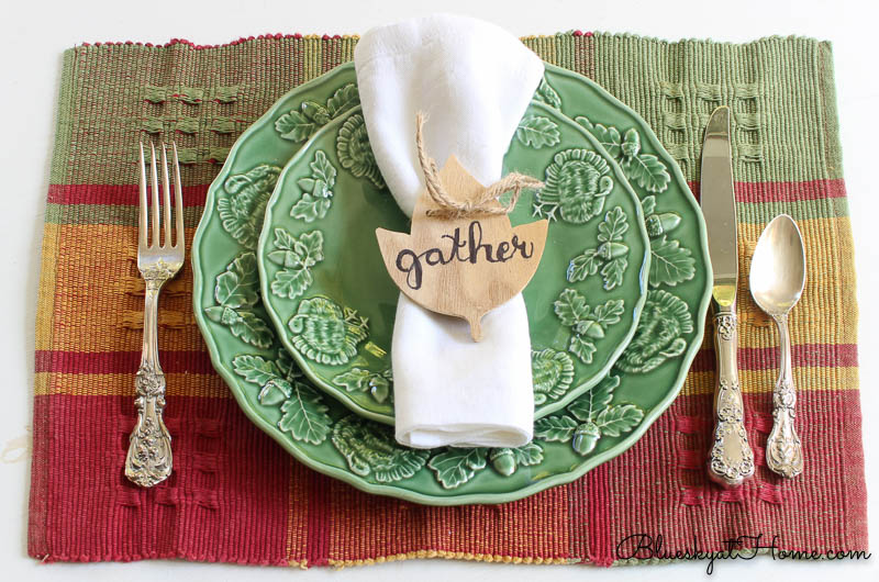 fall place setting with gather napkin ring on green plate