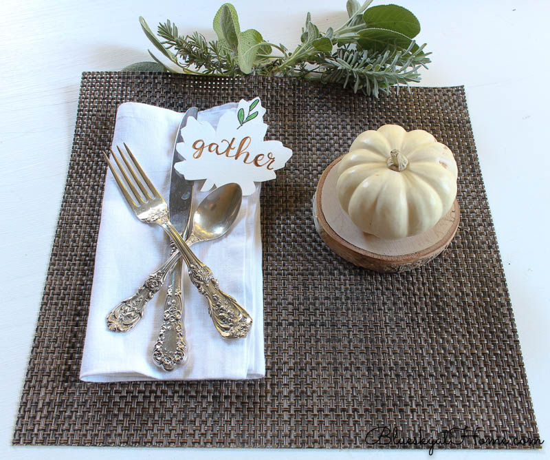 fall place setting with gather sign, pumpkin and herbs