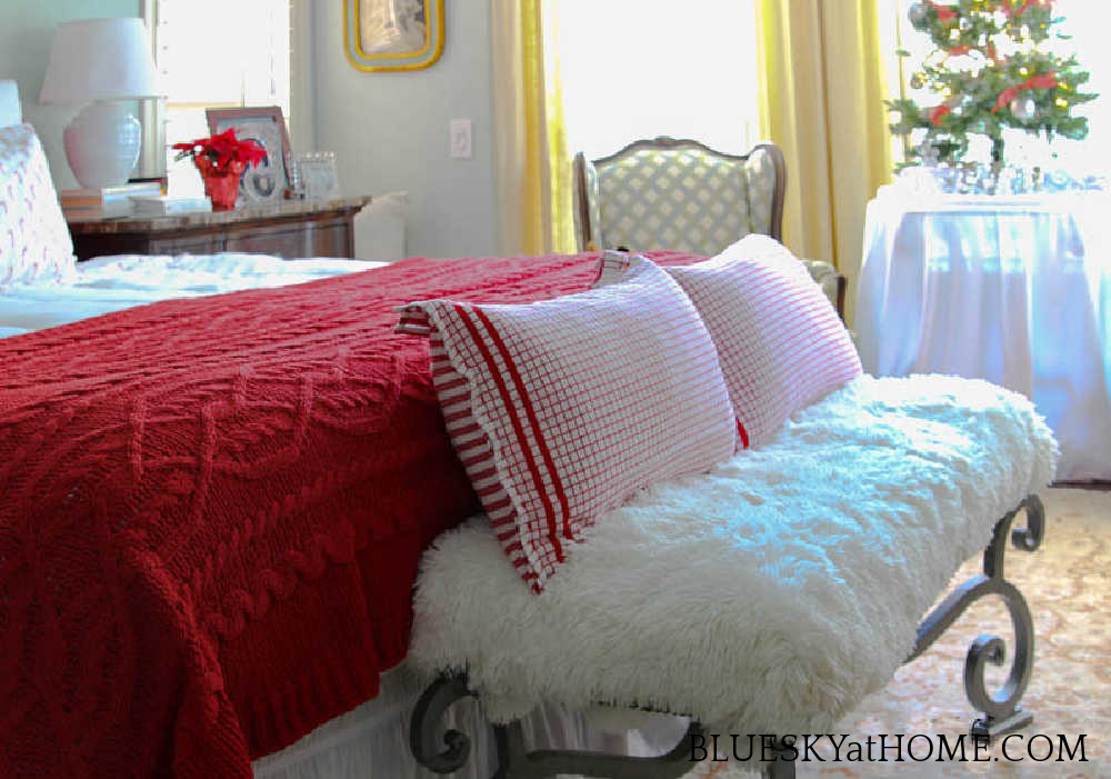 white bench with red check pillows