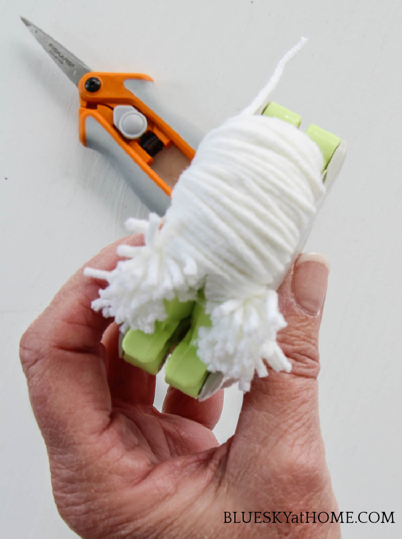 hand holding pom-pom maker