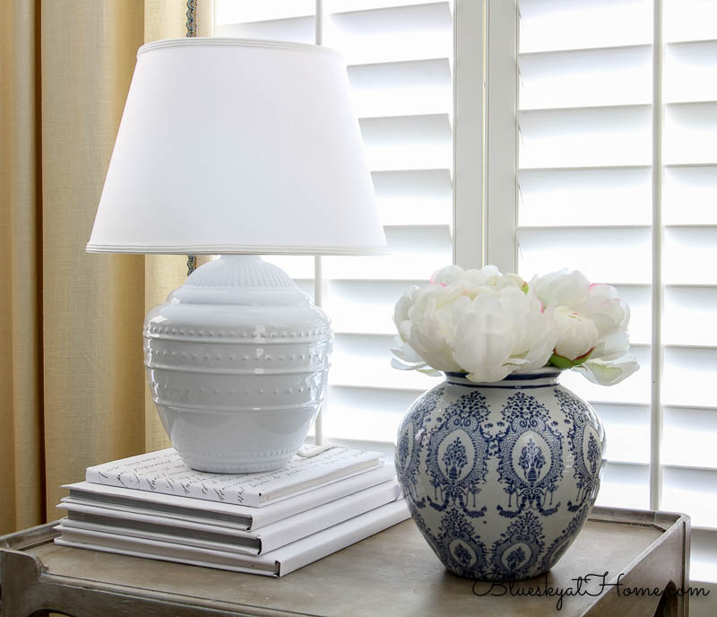 lamp and blue vase on table