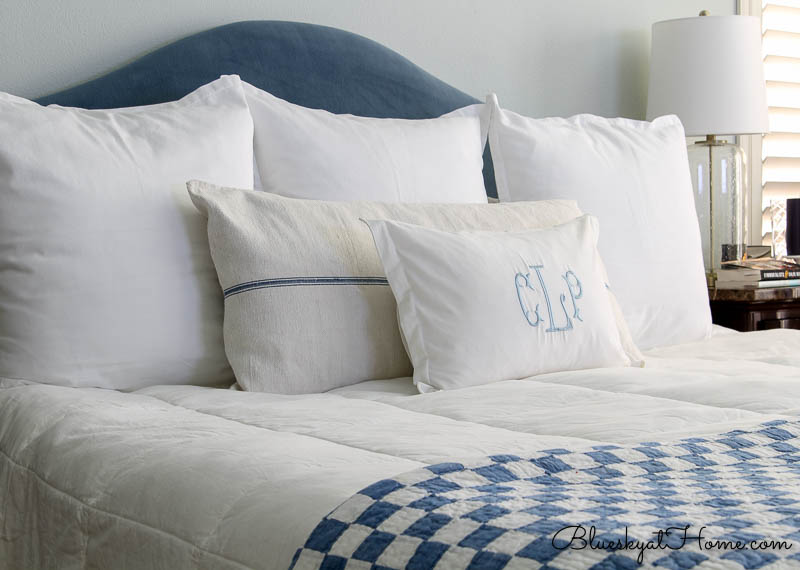 blue and white checked blanket on bed with pillows