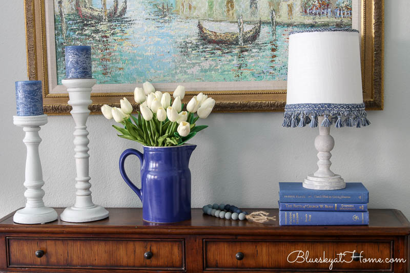 blue pitcher with white tulips and lamp and candlesticks in winter master bedroom