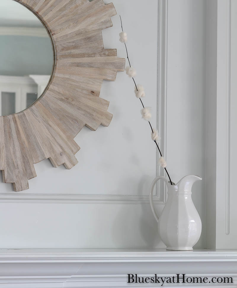 One DIY cherry blossom flowers in white pitcher on mantel