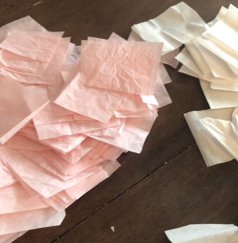 pink and white tissue paper cut into squares