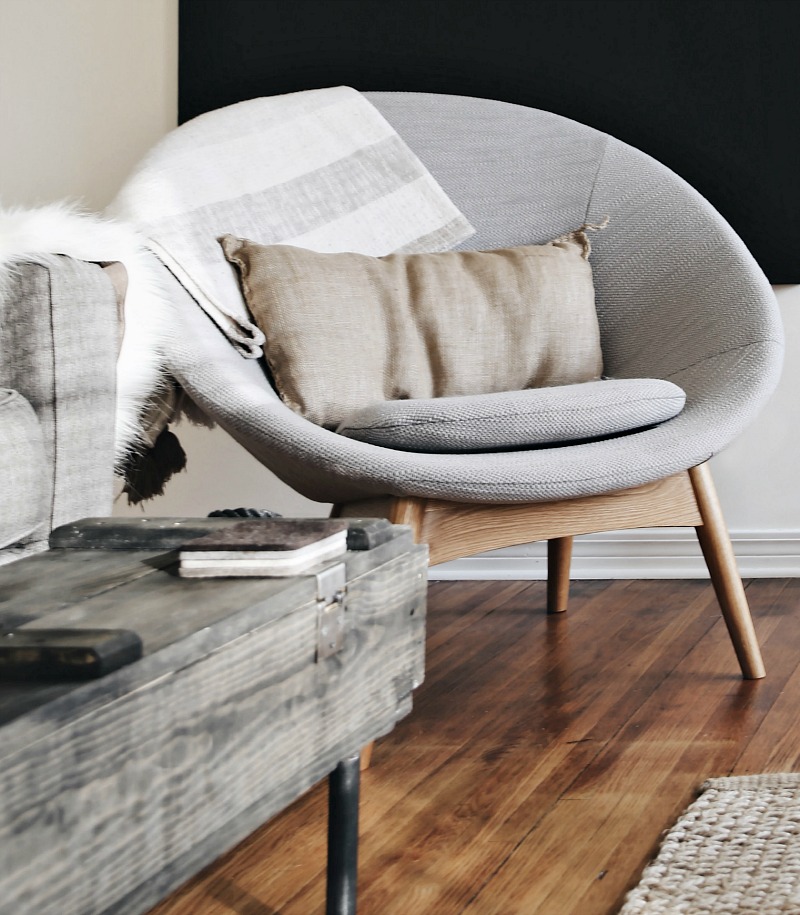 grey chair with pillow and blanket