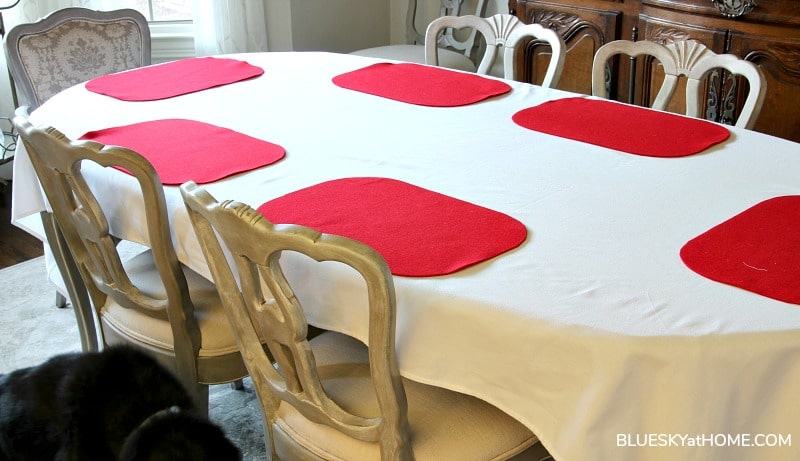 red placemats on white tablecloth