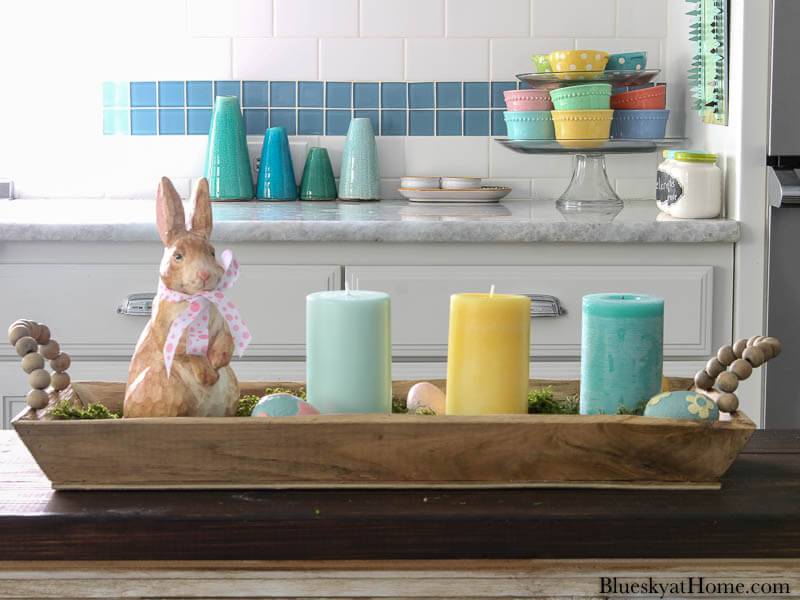 pastel candles on wood tray