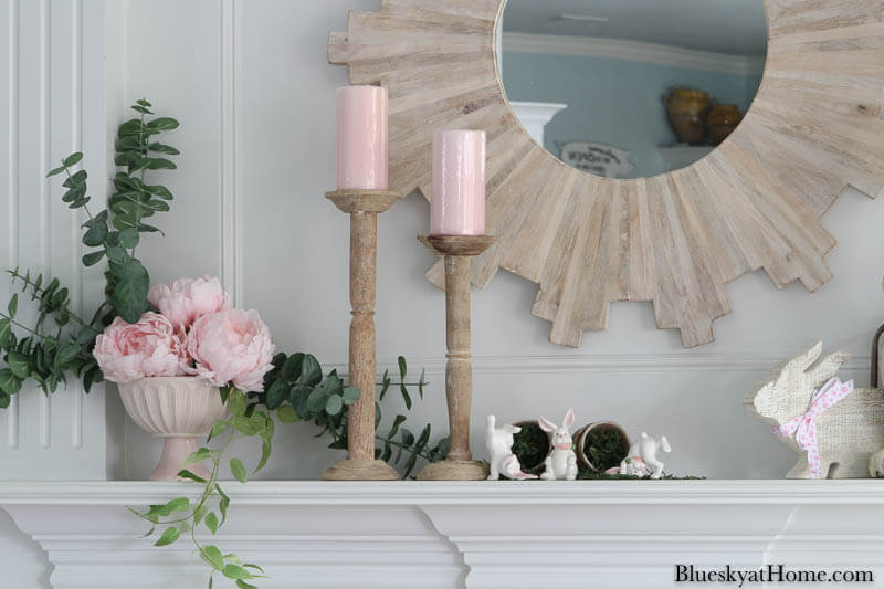 pink candles and pink flowers on mantel