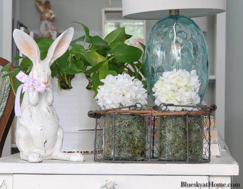 wood bunny and white flowers on table