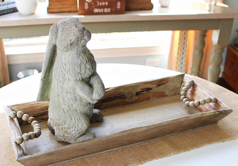 upright concrete bunny in wood dough bowl