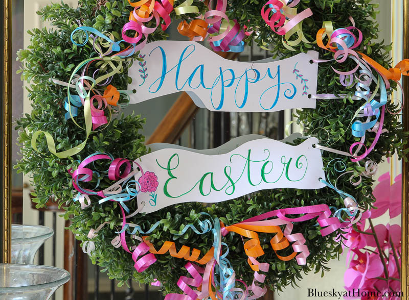 Happy Easter sign and curly ribbon on boxwood wreath