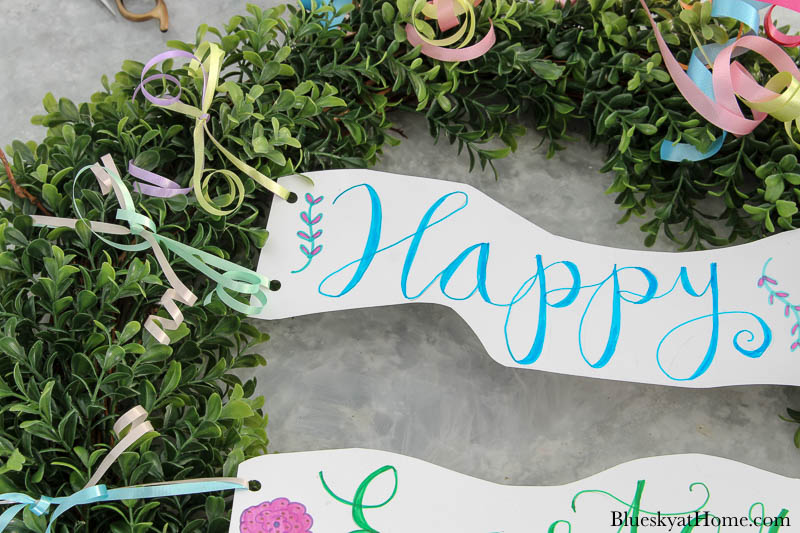 Happy Easter sign tied to wreath