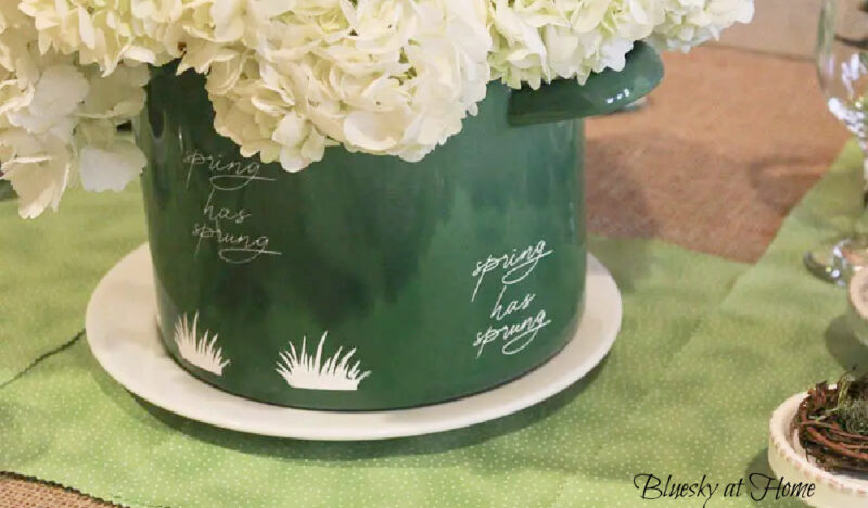 green planter with white flowers