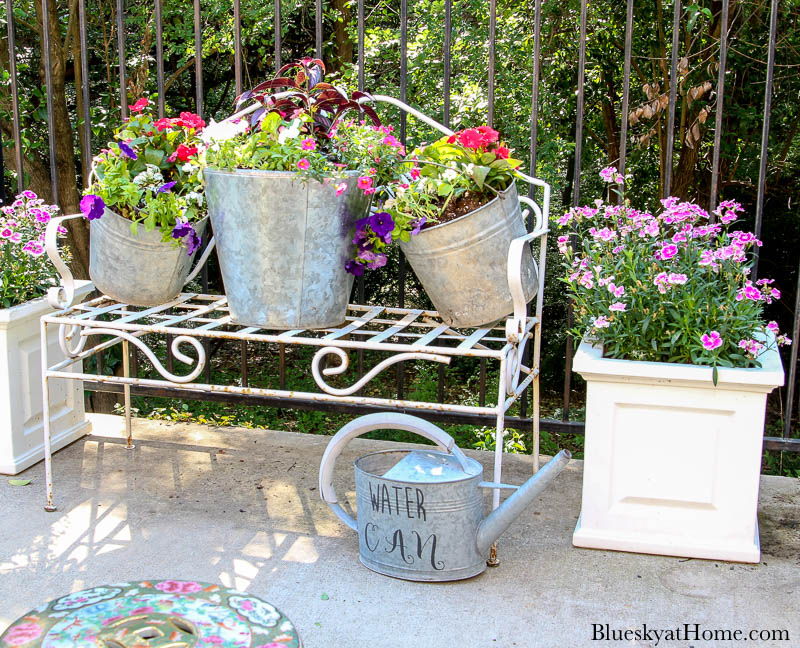 galvanized pails and flowers on bench