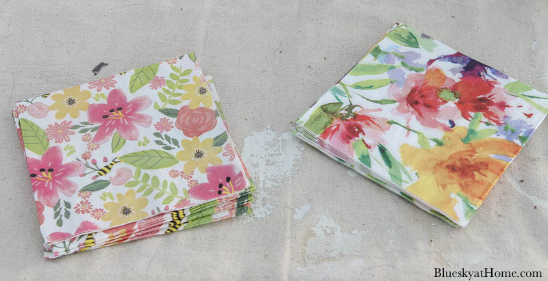 two types of floral napkins in shades of pink, green, yellow and lavendar