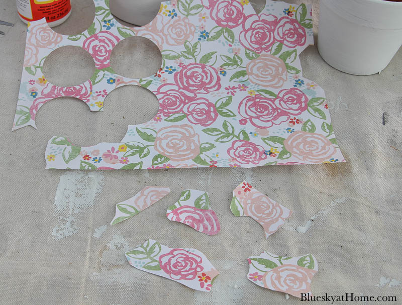 pink and green scrapbook paper with pieces cut out