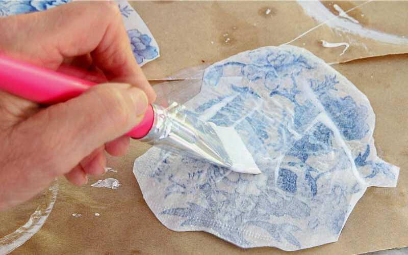 applying Mod Podge to the back of napkin