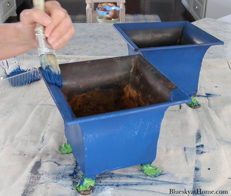 painting discarded containers blue