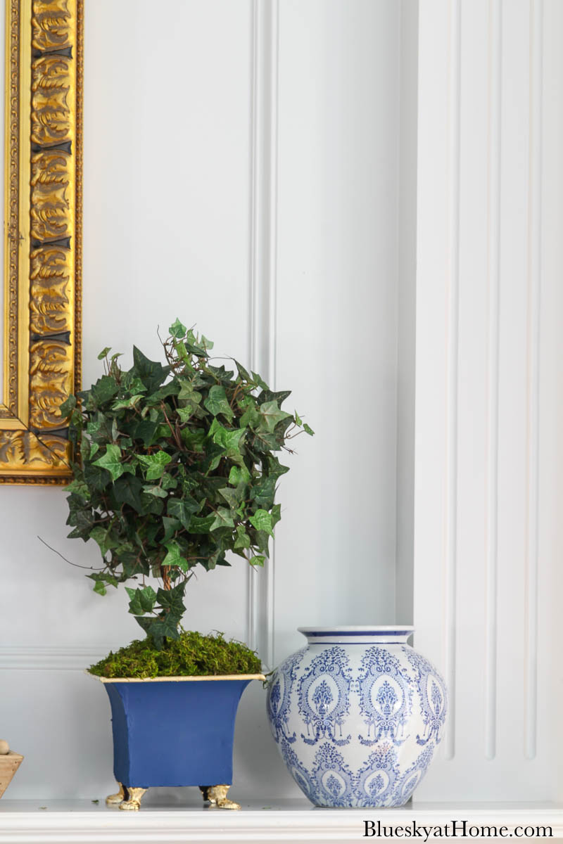 blue painted planter and blue vase on mantel