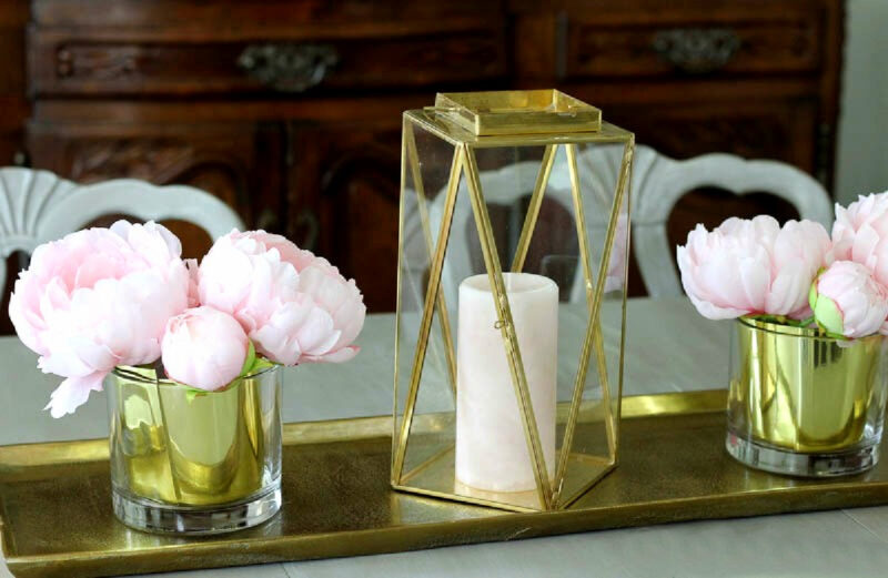 brass and glass lantern with candle and pink flowers