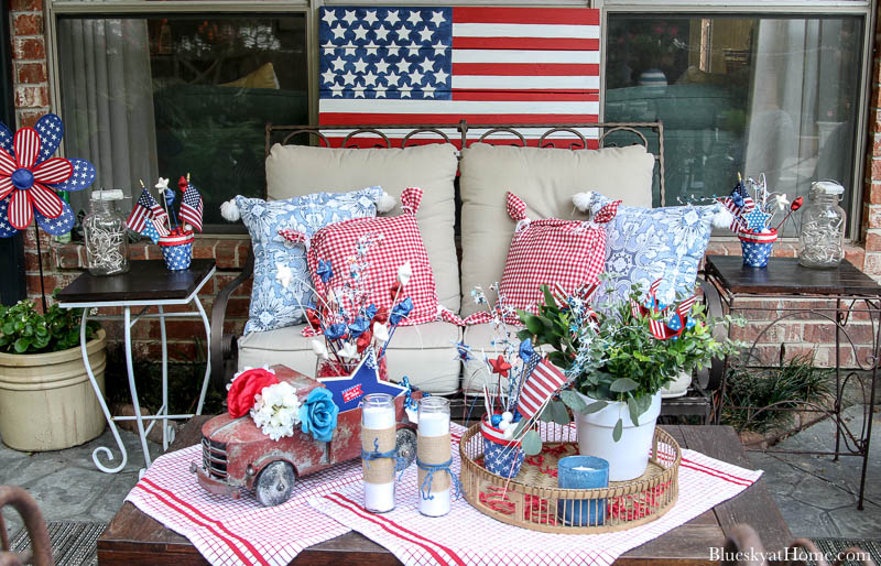 patio loveseat with red and bue pillows and 4th of July decorations