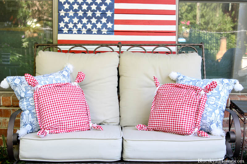 love seat with flag and red and blue pillows