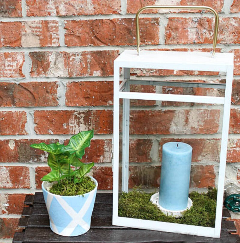 blue candle in metal and glass lantern outside
