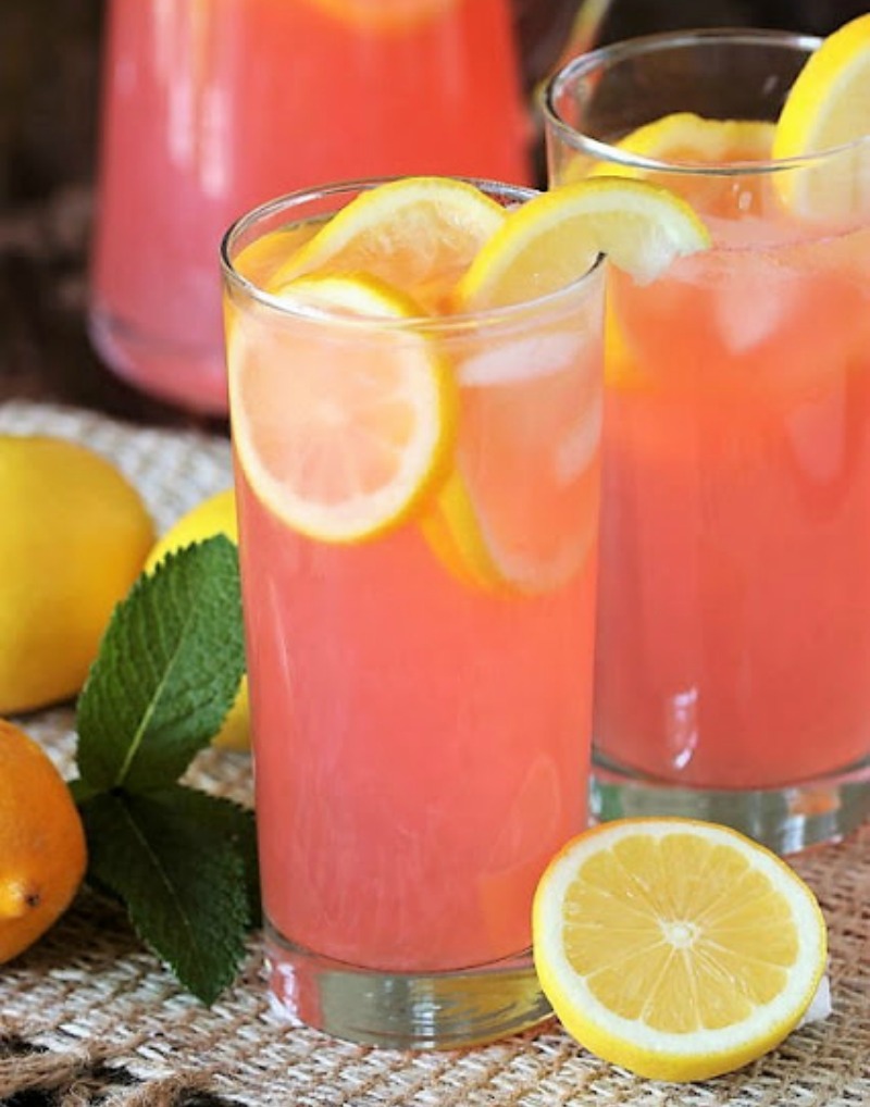 pink lemonade in tall glass with lemon slices