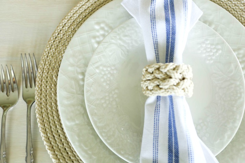 placesetting with cord trim and cord napkin ring on blue and white napkin