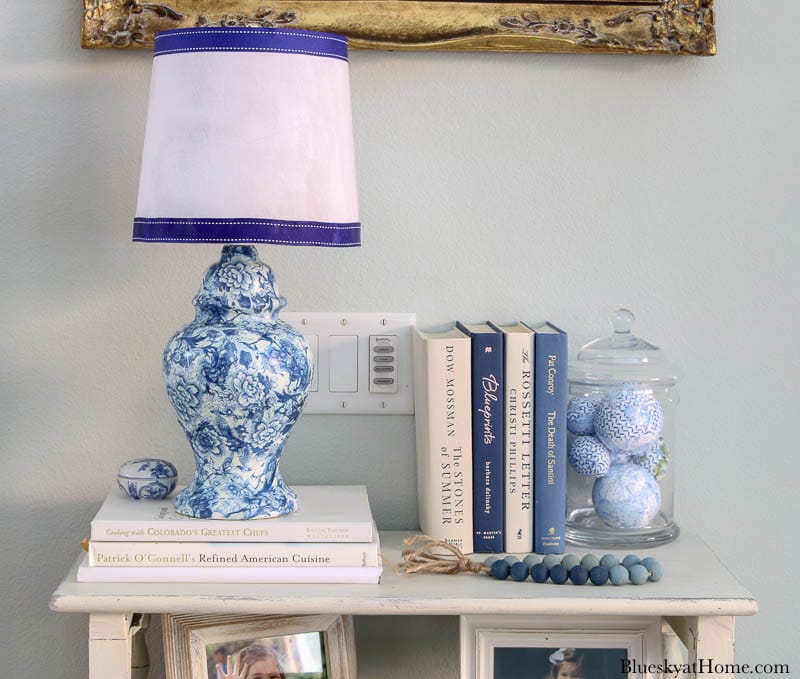 blue and white lamp with white lamp shade on table