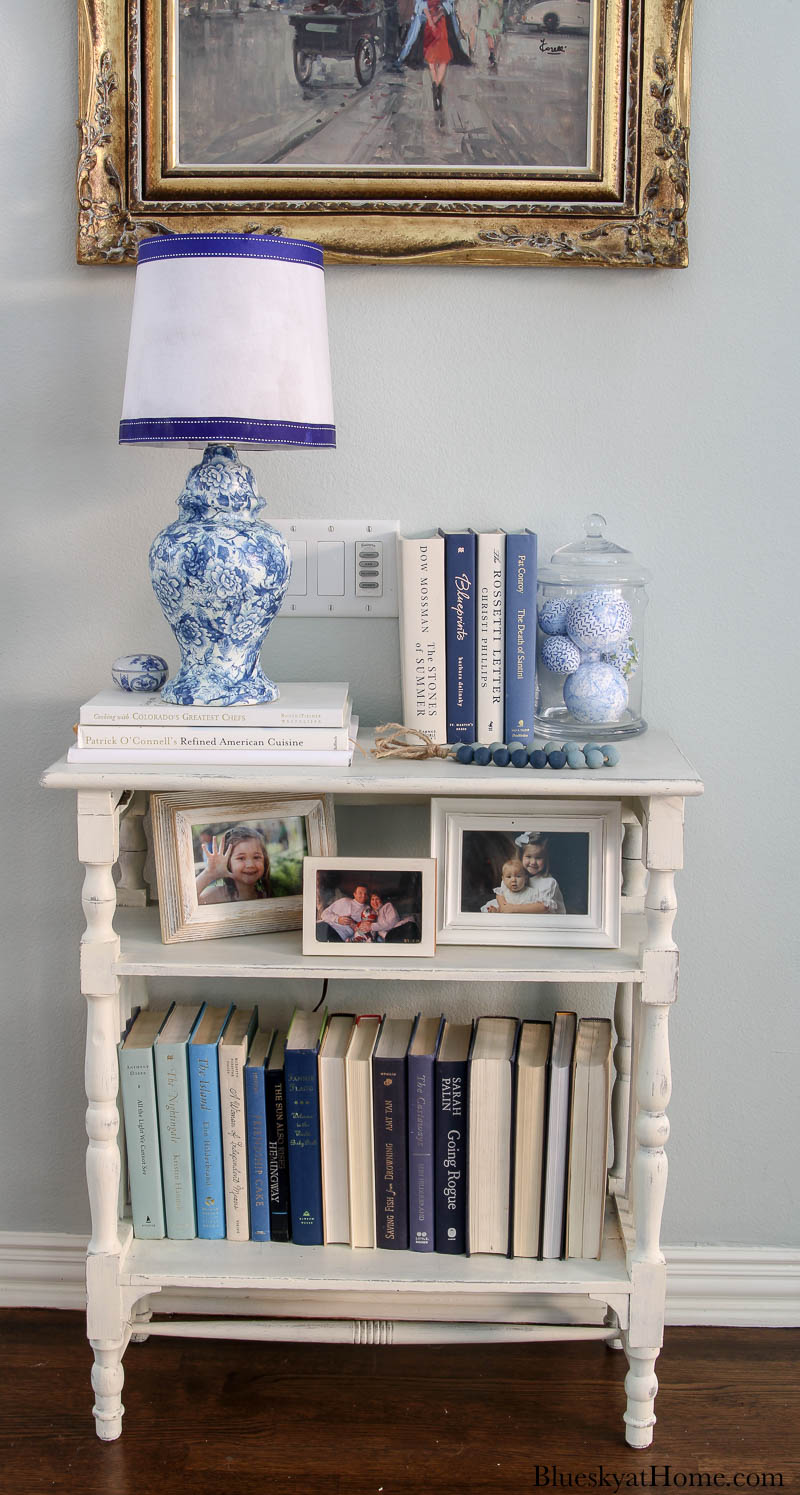 blue and white lamp with white lamp shade on table