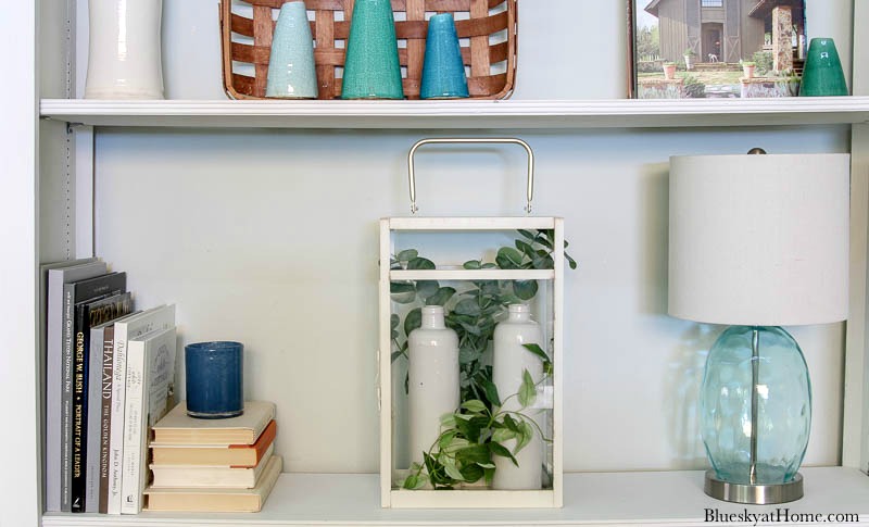 white metal and glass lantern with white vases