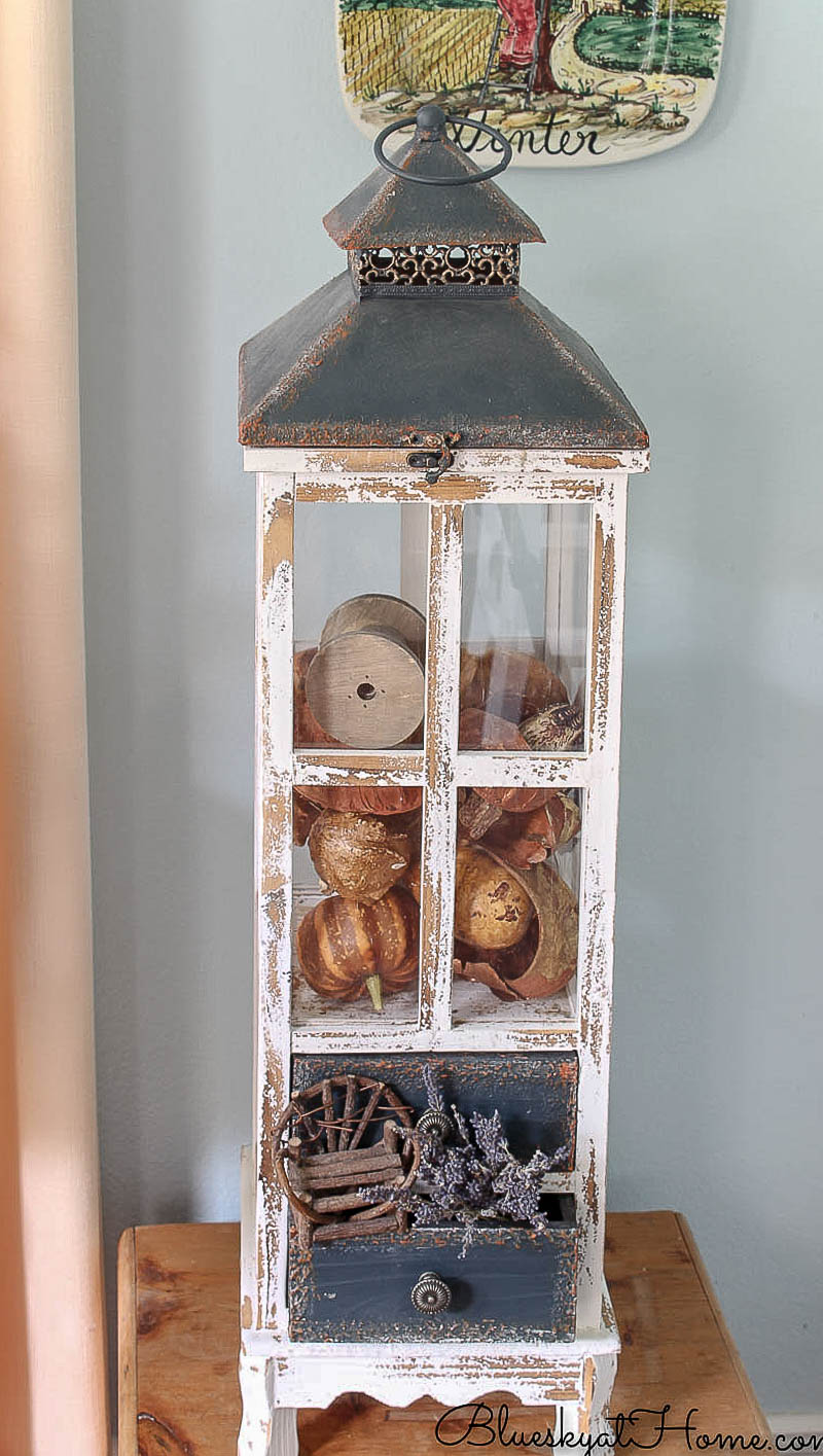 tall wood lantern with fall decorations