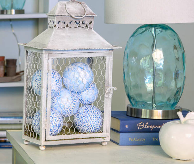 blue and white balls inside grey wred lantern