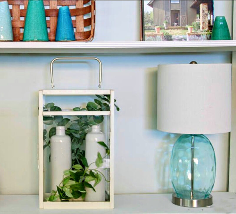 white vases inside white metal and glass lantern