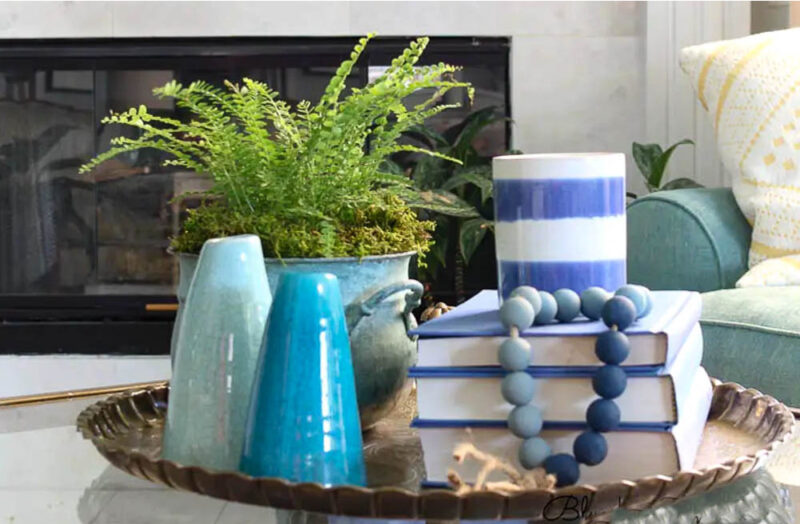 styled coffee table with bue vases