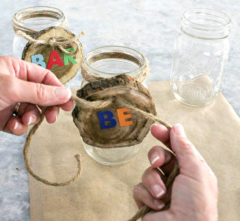 tying bow around mason jars