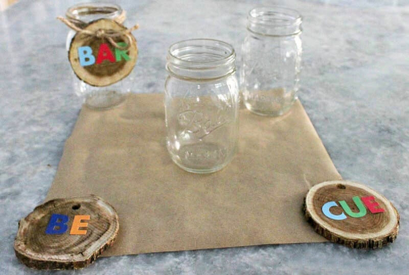 mason jars and wood slices with letter stickers
