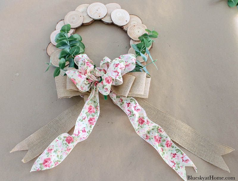 wood slice wreath with faux greenery and floral bow